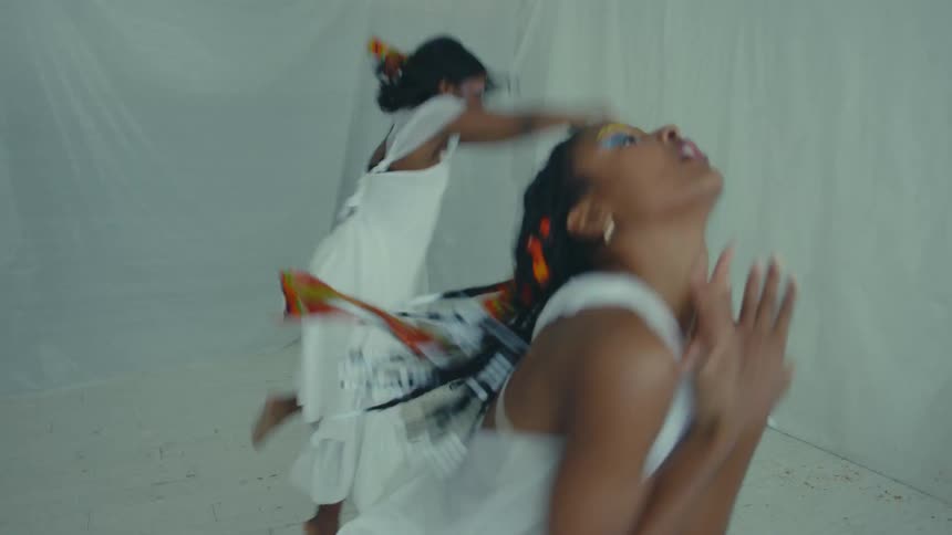 Women in white dresses are dancing