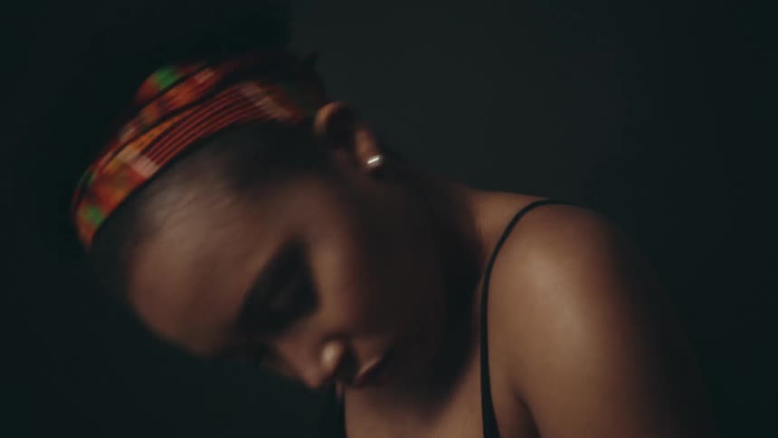Female dancer dances alone against a dark background
