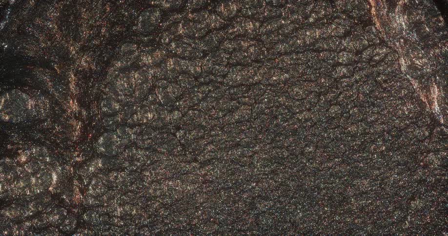 Bubbles burst through the surface shimmering in the light