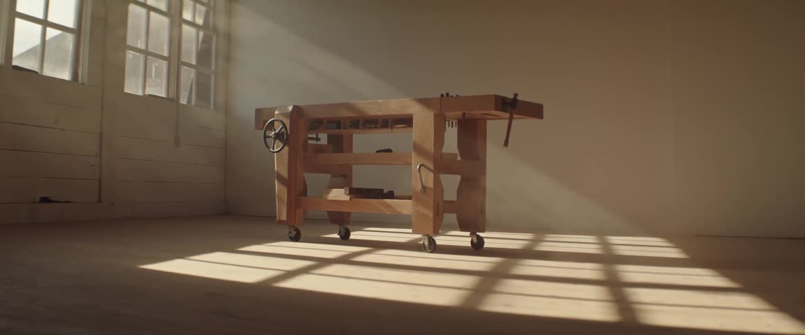 Rolling workbench stands in room near window letting in rays of light