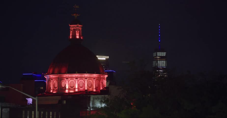 Lights flashing around a domed building in a city