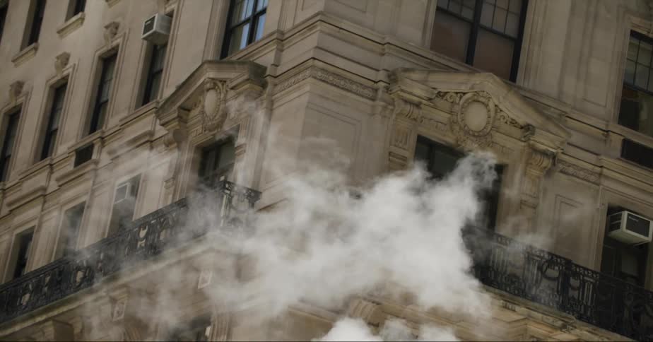 Steam drifts past windows on a building