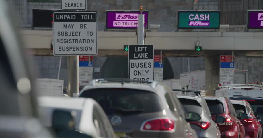 Lines of cars and trucks at a city toll booth