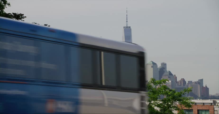 A city bus drives past downtown