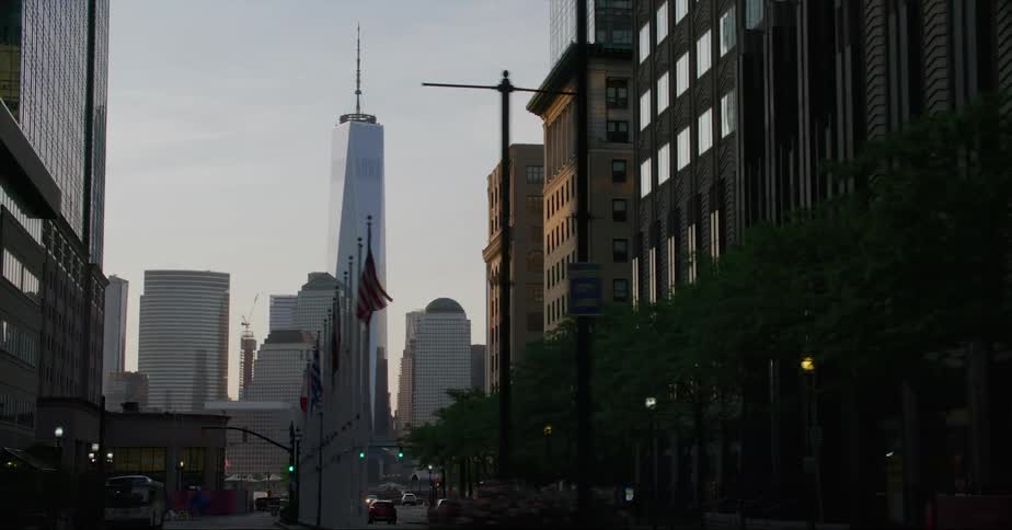 Rows of flags hang on poles along a city street
