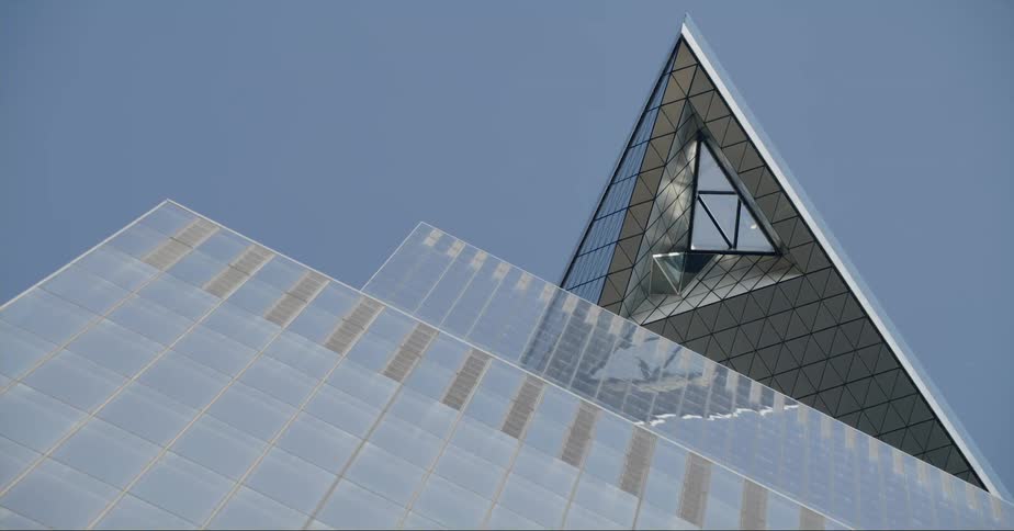 Top of a tall skyscraper in new york city against the blue sky