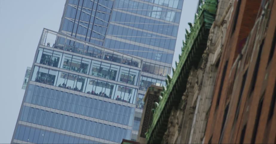 Workers move inside an office building in a city