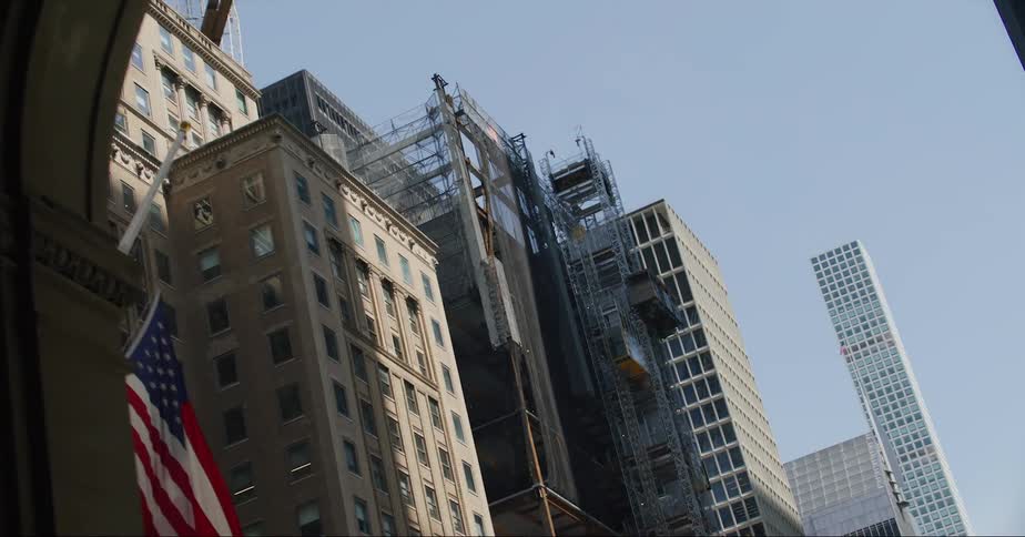 Facade of the buildings on the city skyline seen from a moving vehicle