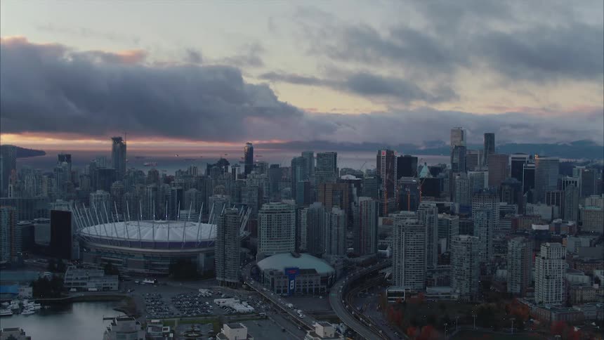Aerial view of stadium high rise buildings and skyscrapers in the city at dusk