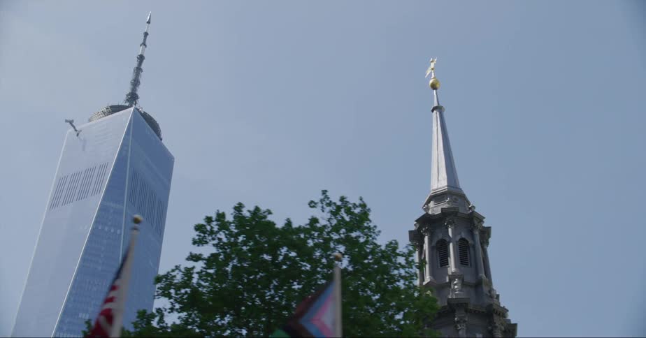 Intricate details and statue are on a building in the inner city surrounded by skyscrapers