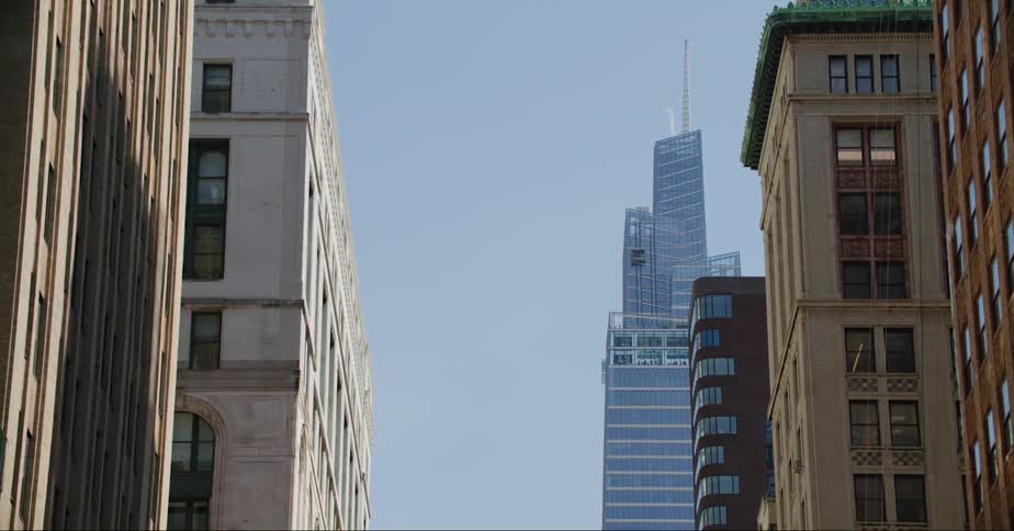 Skyscraper with spire and apartment buildings in the city