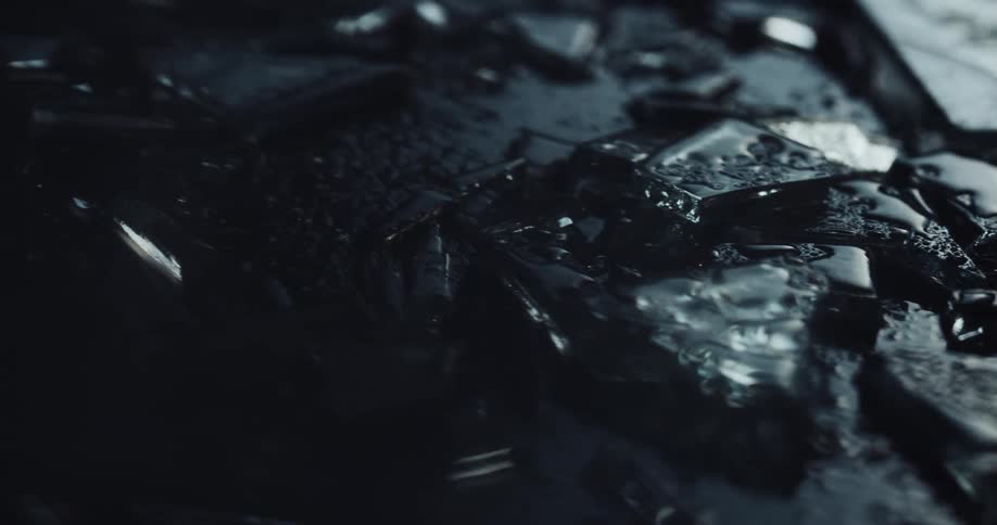 Close up of broken shards of glass while raining at the crime scene