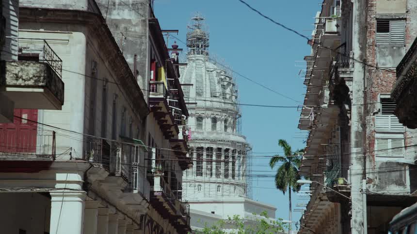 Apartment buildings in front of a large domed building