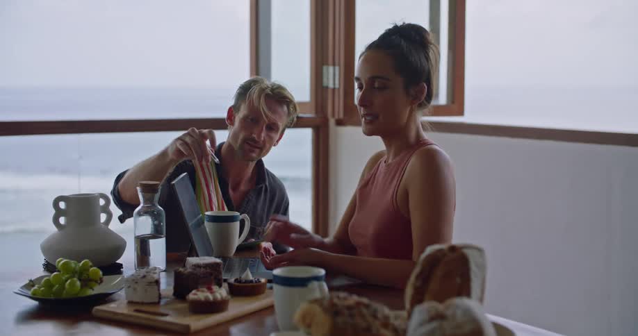 Two friends are talking together at a table