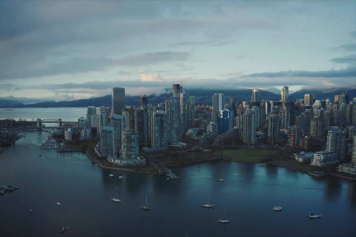 An aerial hyperlapse view of downtown Vancouver with tall buildings near False Creek