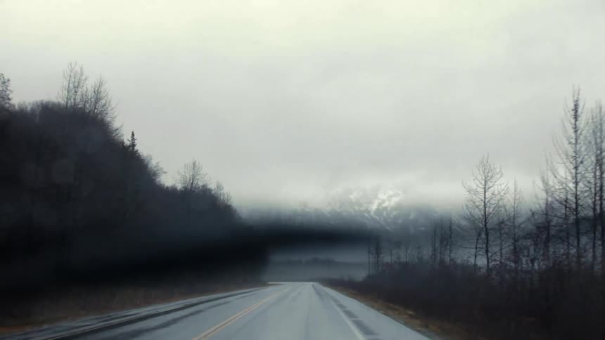 Windshield wipers clear rain from a windshield