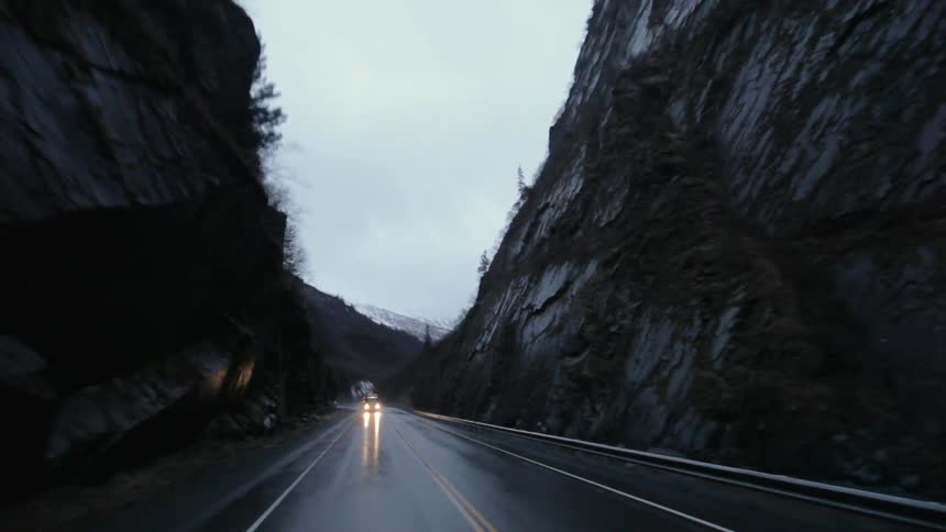 A car drives through a valley