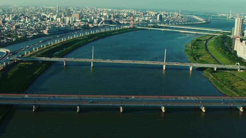 Aerial view of cars driving on a bridge is displayed in spring