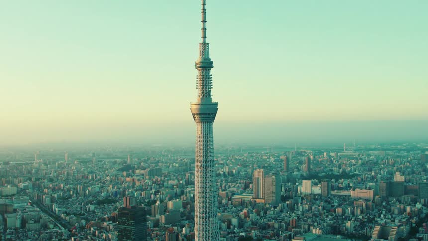 A tall tower in a city at sunrise
