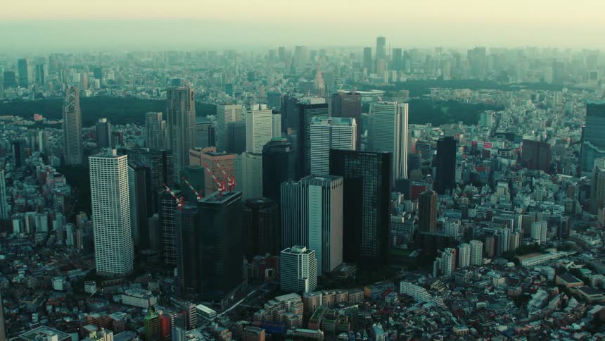An aerial view of dense buildings and skyscrapers in a large city