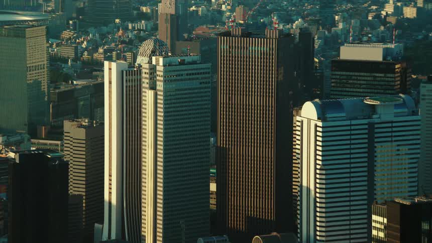Tall skyscrapers line a smog covered city