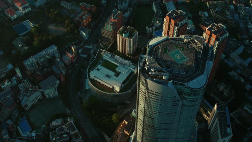 Aerial view of high rise office buildings in a city with cars driving past