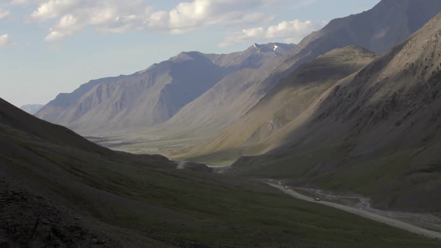 Highway road in between large mountains