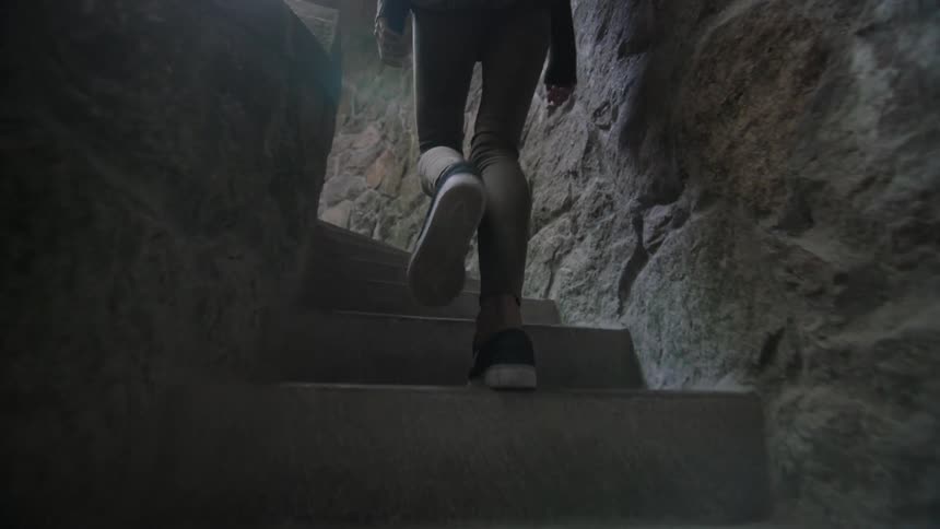A person climbs stone stairs