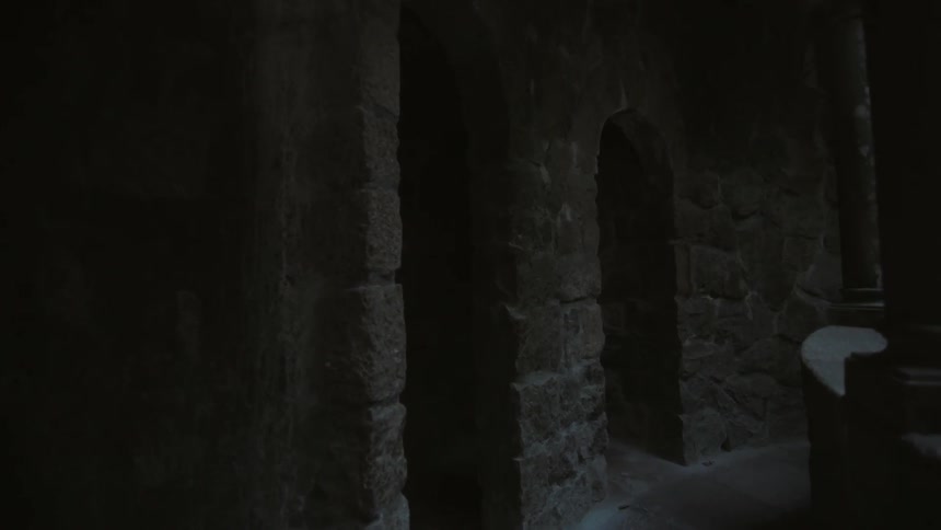 A monument has stone pillars and arches