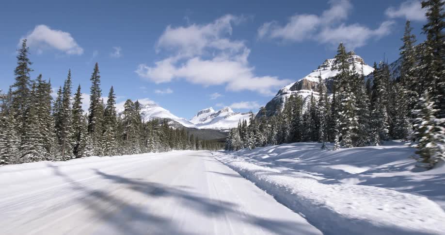 Moving down a snow covered road towards a mountain