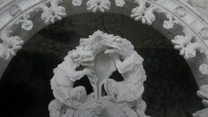 Statues of two creatures are under an arch