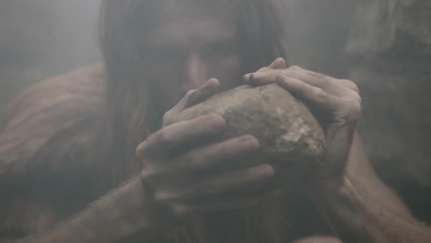 A man is holding a rock