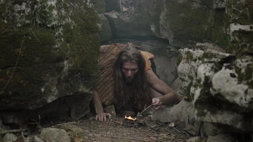 A man builds a fire