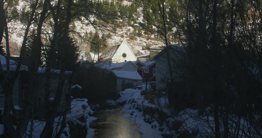 A small stream is before some homes