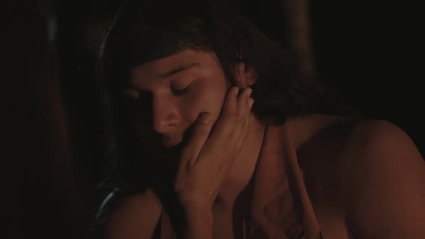 A person touches a young man's face