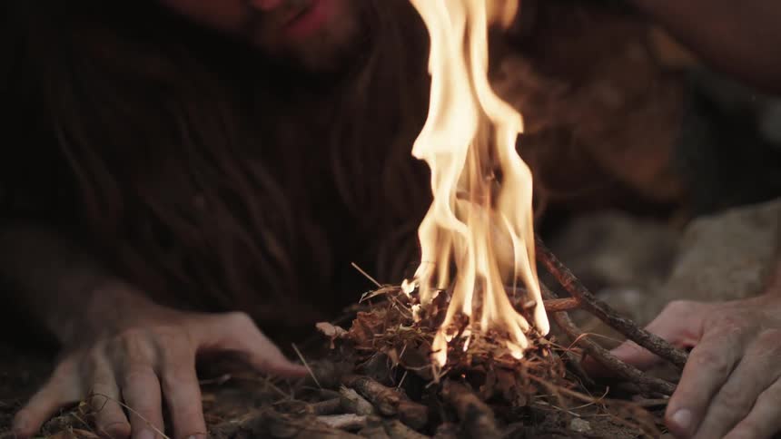 A man lights a fire