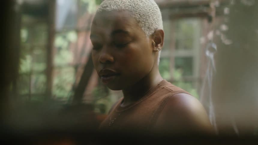 A woman walks around the greenhouse