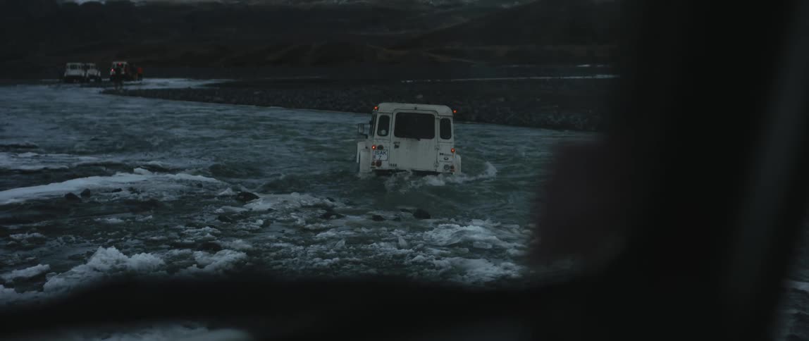 A truck driving through a river