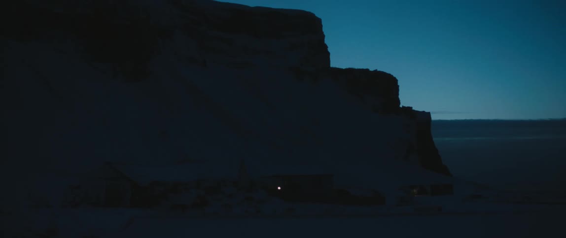 A cliff on the beach at night