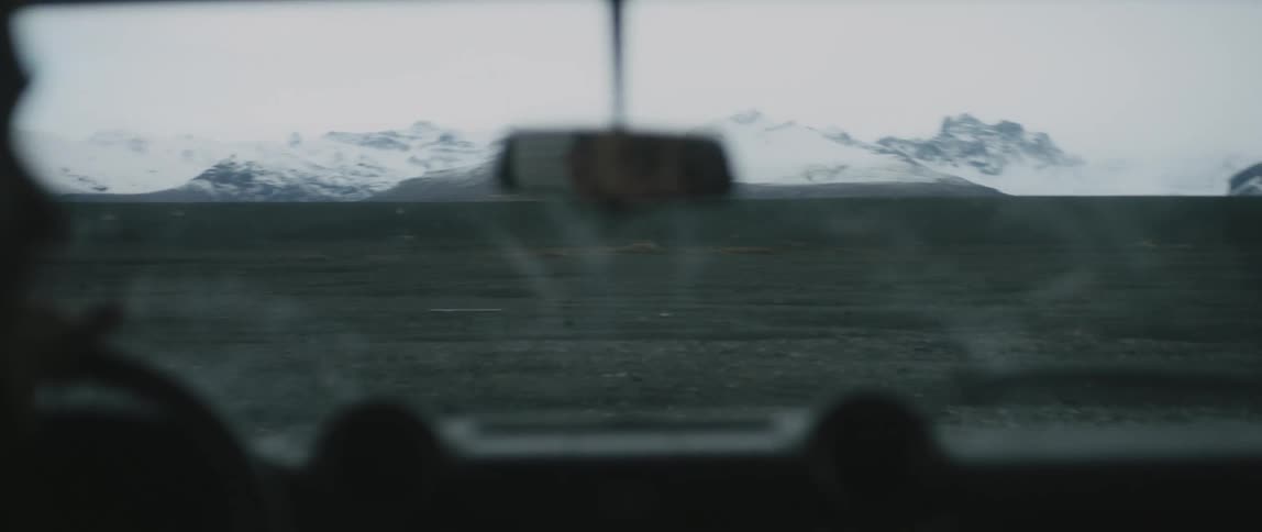 A person is driving off road near mountains