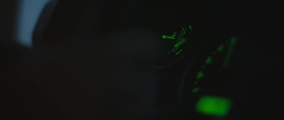 Dashboard lights glow bright green in a vehicle