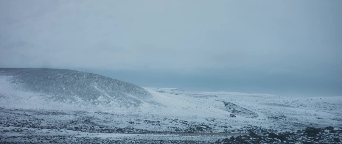 A car is driving through an arctic area