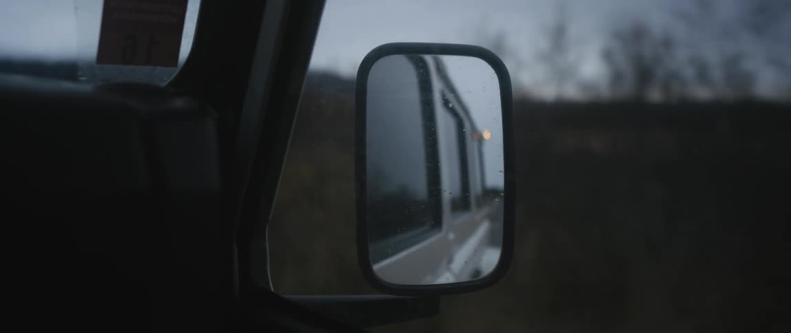 A vehicle drives past the fields