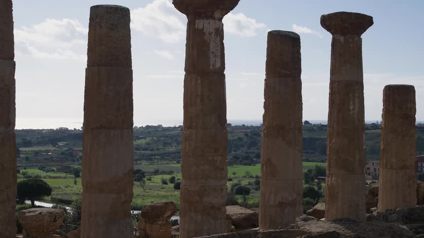 Old pillars stand in a rural area