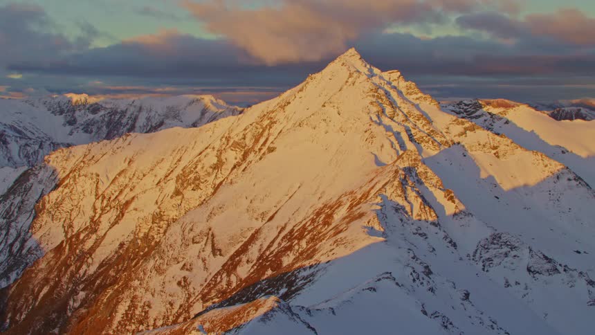 Sunlight and shadow on snow dusted mountain ridges and peaks