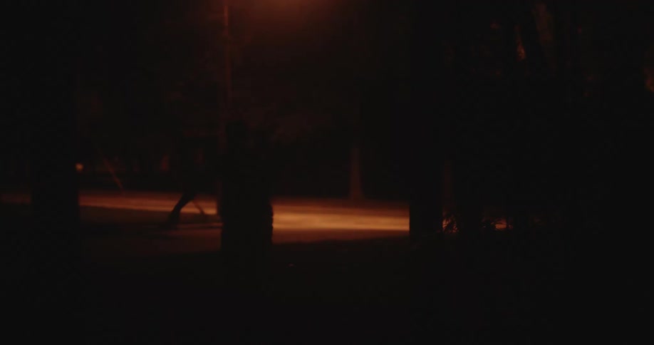 Person chases after man running in the street at night