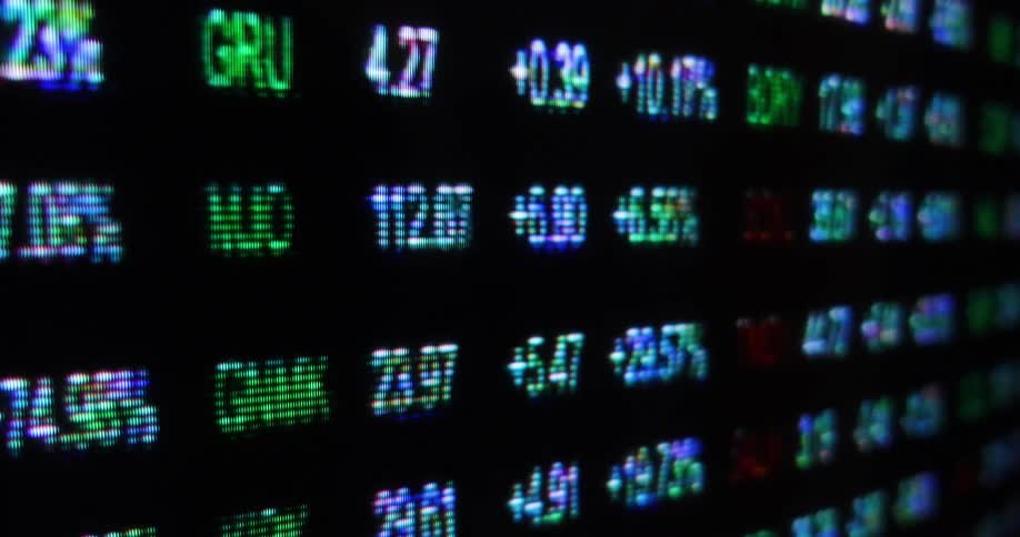 Digital numbers rapidly change in a glitching movement on a large screen
