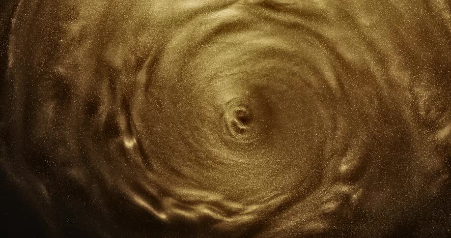 Golden grains of sand swirl in circle
