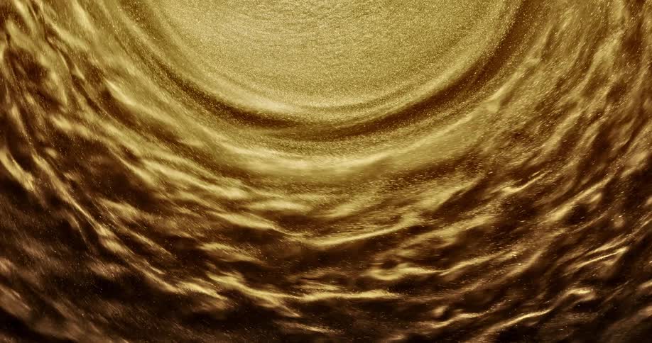 Grains of golden sand spin and wave in a circle