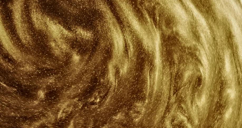 Gold glitter moves in a spiral pattern